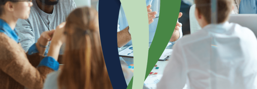 Image representing happy employees at a conference table for HR Compliance Calendar 2024